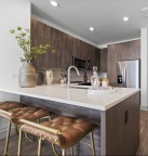 a kitchen with seating and wood cabinets