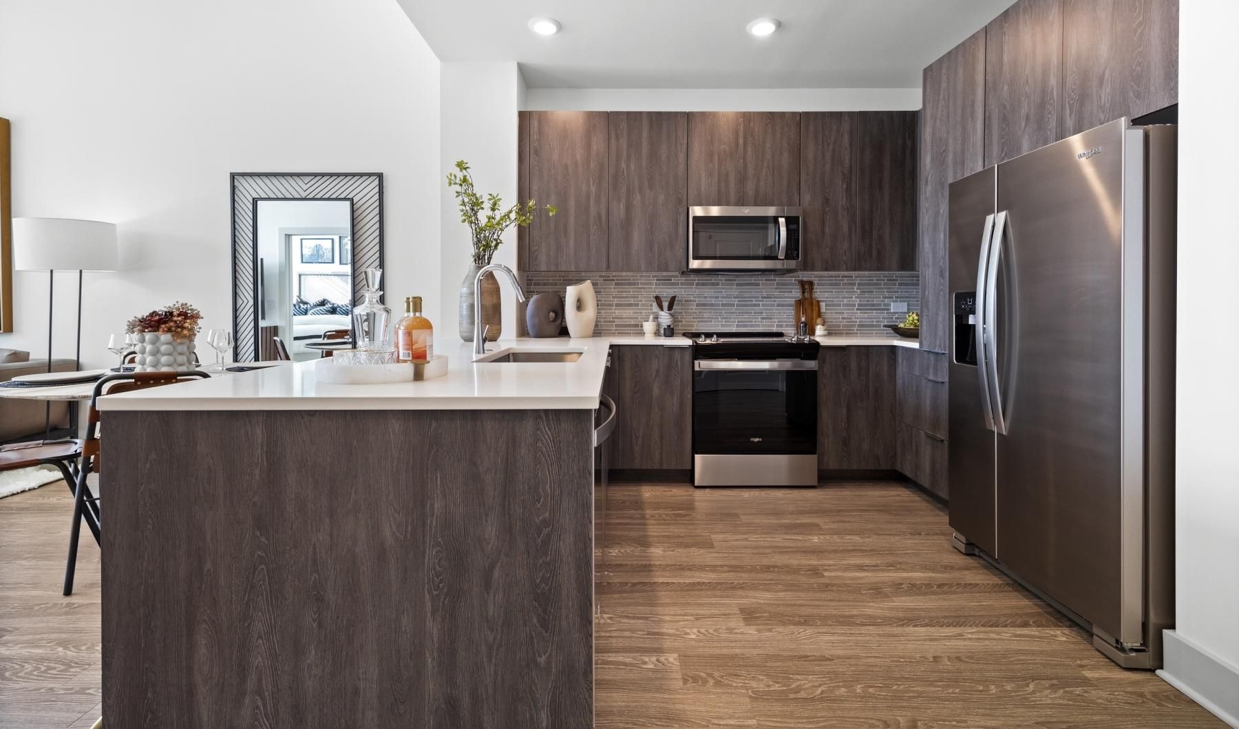 a kitchen with brown wood and a large island